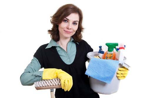 Housekeeper making a bed during Airbnb cleaning turnover